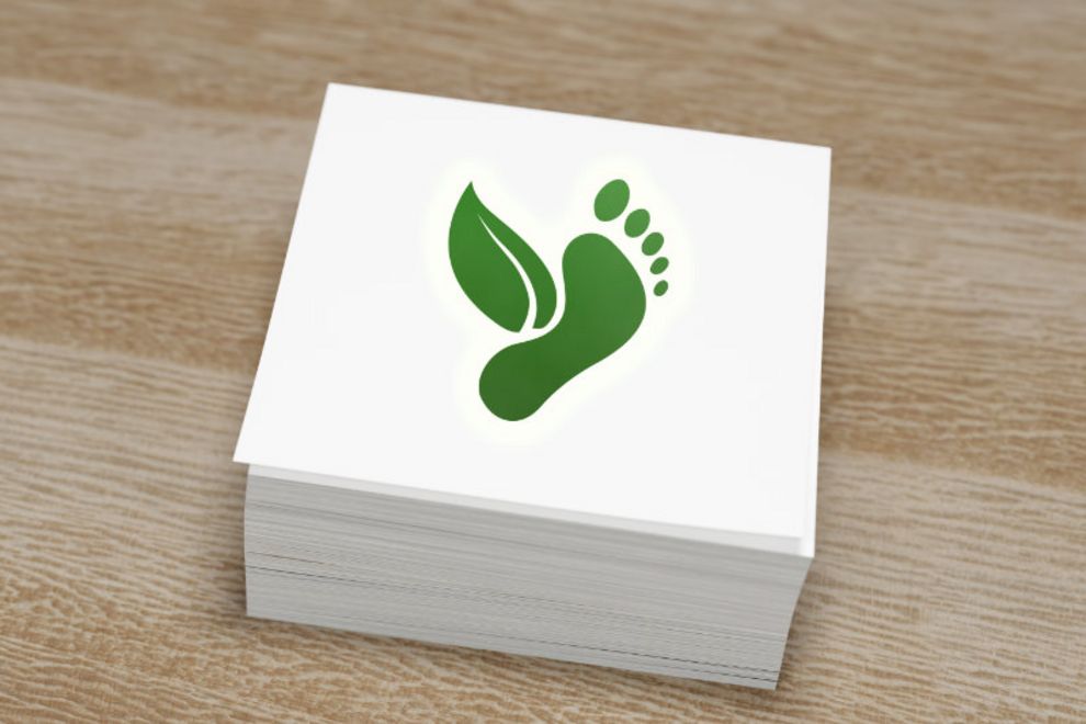 Environmental, climate change concept in a wooden block; Carbon Footprint, zero emission concept. Carbon ecological footprint symbols on wooden background with eco friendly icons on a paper pad. Sustainable development strategy. 3D render illustration