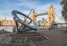 Picture of sundial in London with Tower Bridge in the background