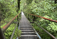 Very long steep staircase at the edge of the rock face.