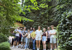 Group photo in a green courtyard